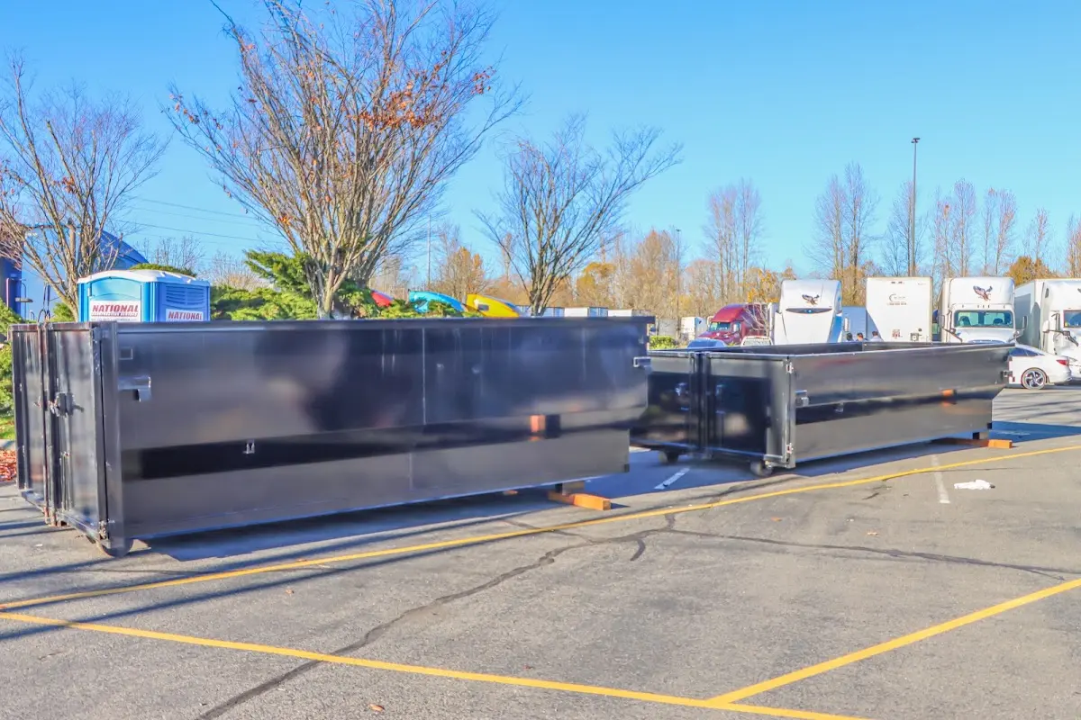 Professional dumpster rental service with roll-off container on residential driveway in Susquehanna